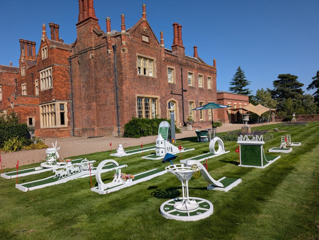 Luxury 9-hole wedding mini golf course by Crazy Weds Golf Hire set up on the lawns of Hodsock Priory for a country house wedding in Nottinghamshire.
