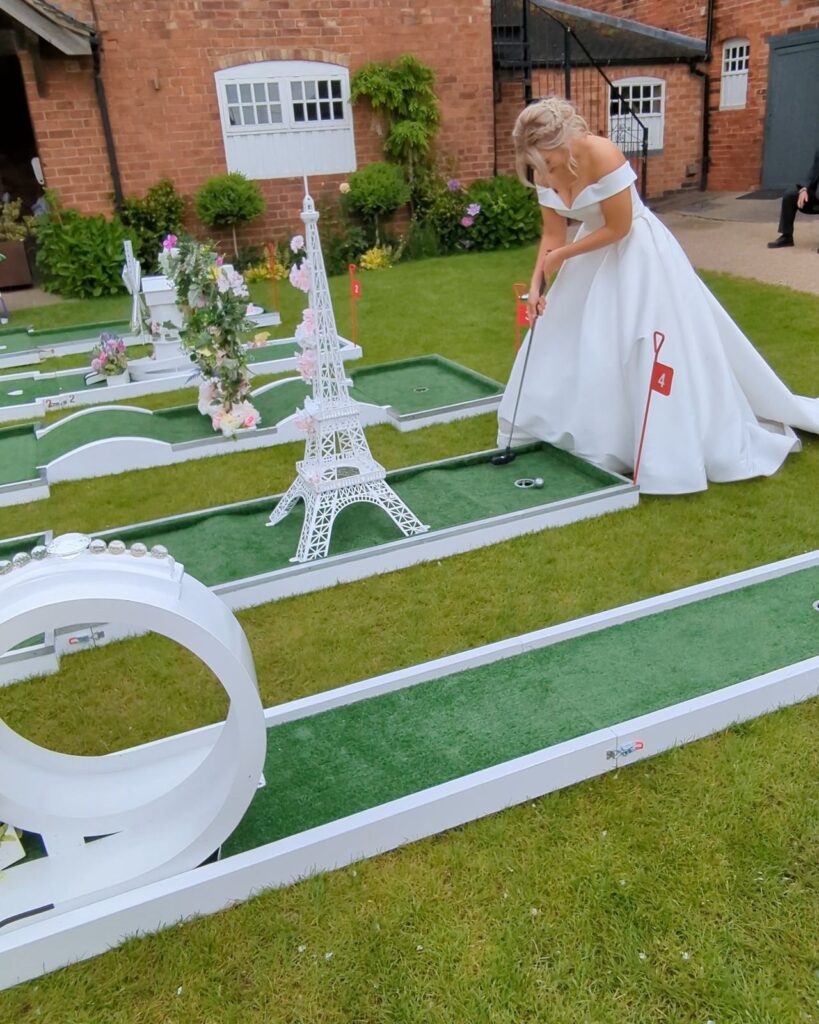 Guests playing wedding crazy golf at Donington Park Farmhouse