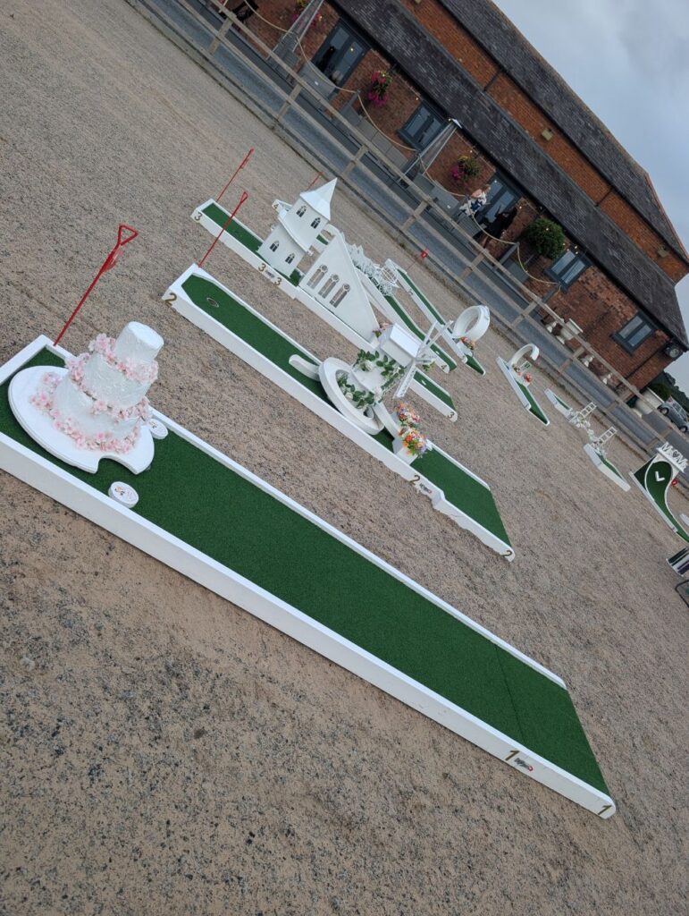 Wedding crazy golf holes beside the red-brick buildings at Burlton Manor