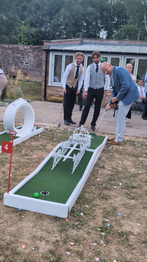Guests playing wedding crazy golf beside the barns at Foxtail Barns