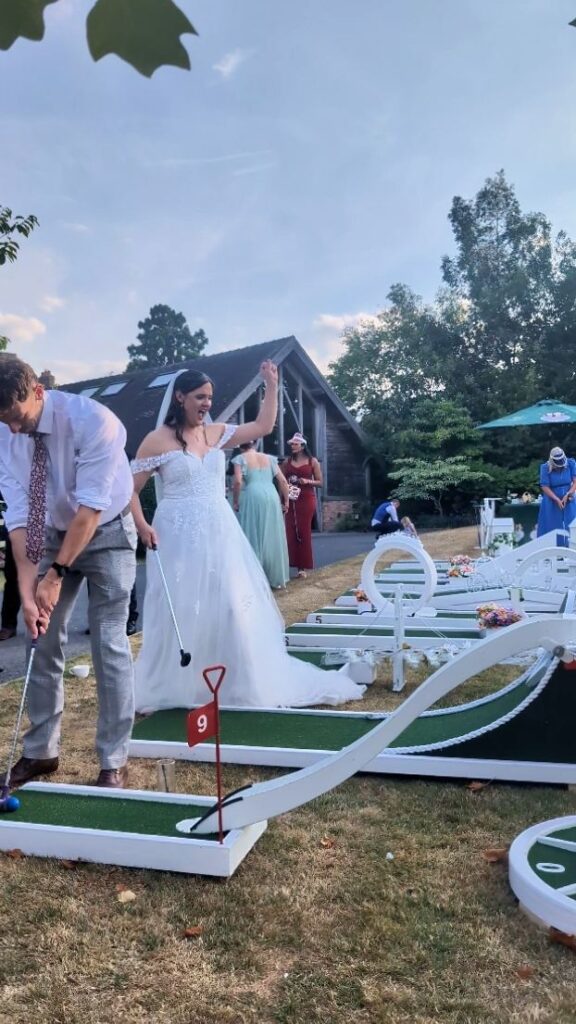 Wedding guests enjoying the crazy golf course at Mythe Barn