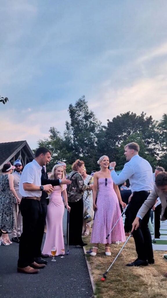 Wedding guests playing crazy golf beside the drive at Mythe Barn