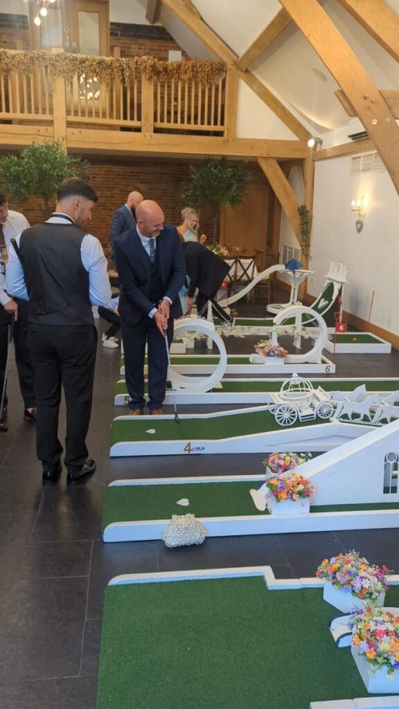 The Crazy Weds wedding crazy golf course set up indoors inside the oak-beamed barn at Mythe Barn
