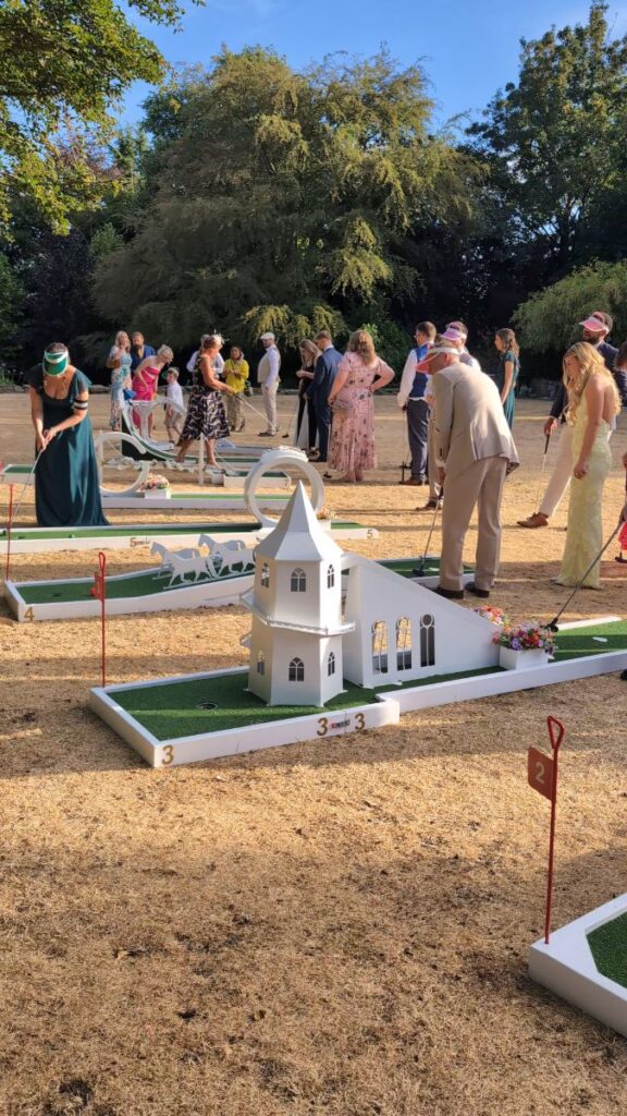 Wedding guests playing the Crazy Weds crazy golf course on the lawn at Ringwood Hall, Chesterfield