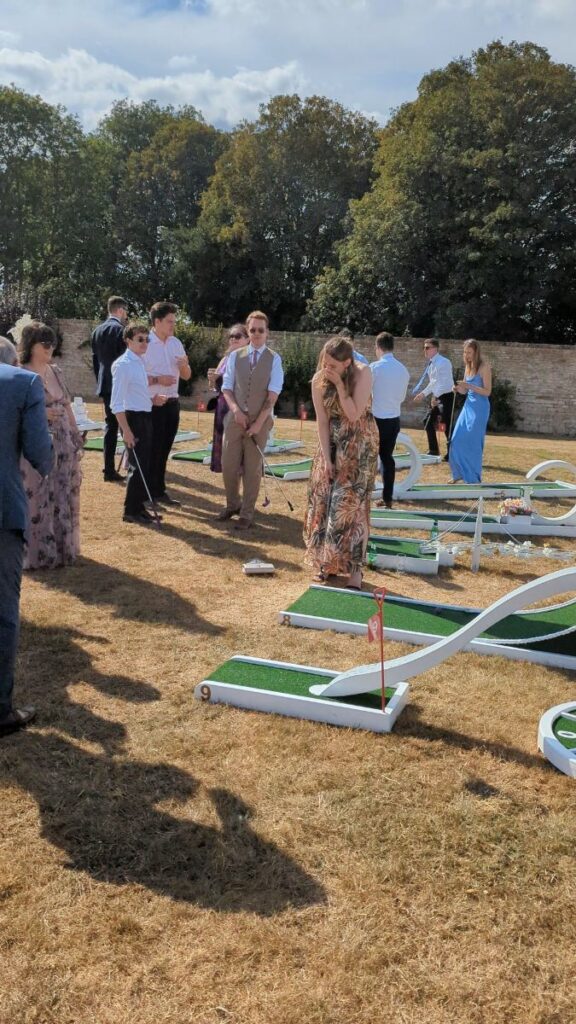 Wedding guests gathered around the crazy golf course at Normanton Park Gardens