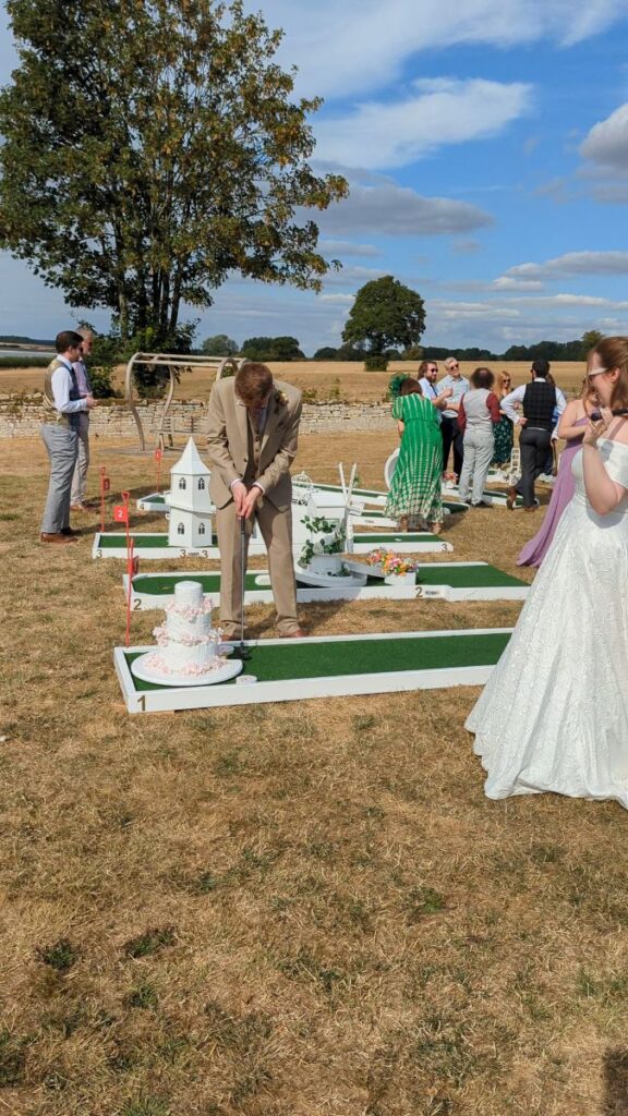 Bride and guests enjoying wedding crazy golf at Normanton Park Gardens, Rutland Water