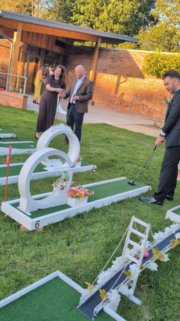 Wedding guests playing crazy golf beside the Ceremony Room at Thorpe Garden