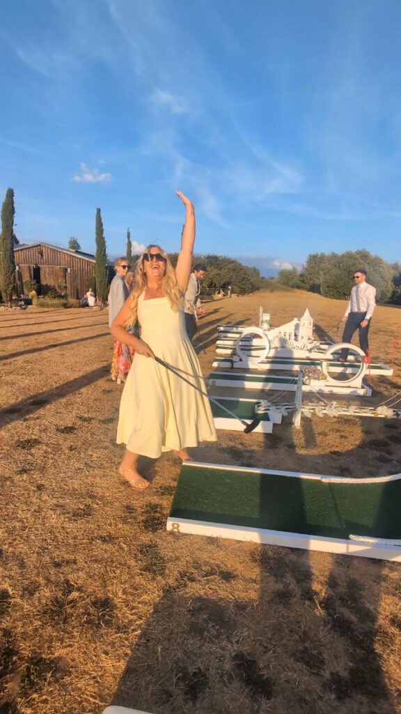 A wedding guest celebrating on the crazy golf course at The Willow Marsh Farm