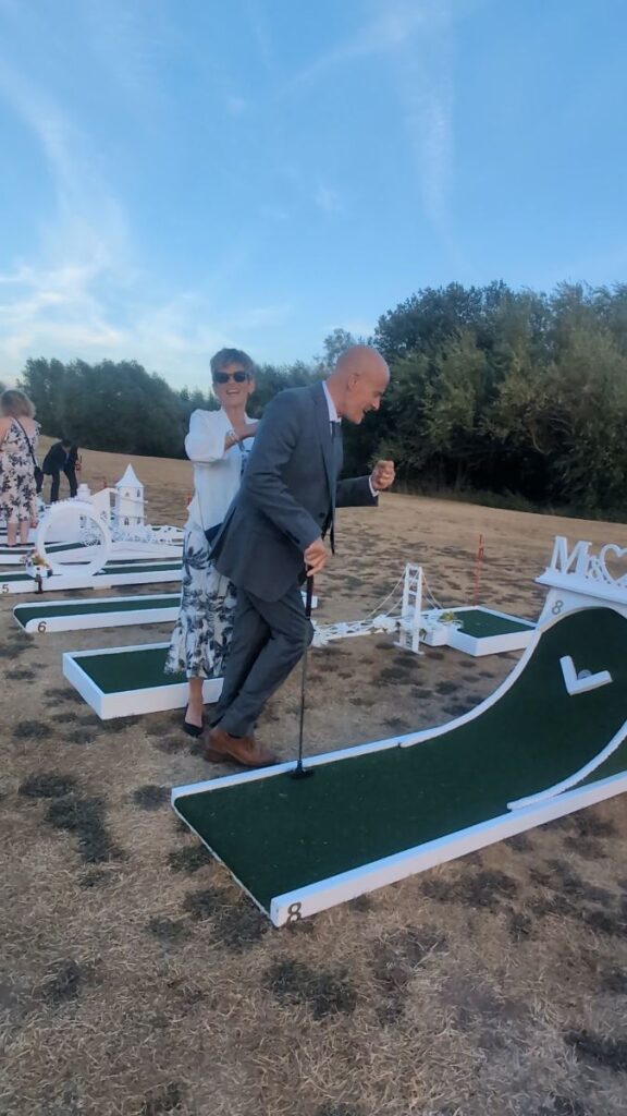 A wedding guest taking his shot on the crazy golf course at The Willow Marsh Farm